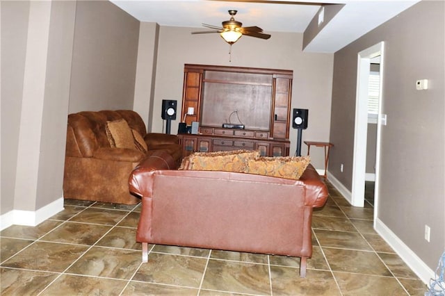 living room with ceiling fan and tile patterned floors