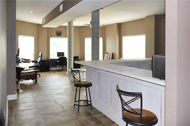 bar featuring tile patterned floors and a wealth of natural light