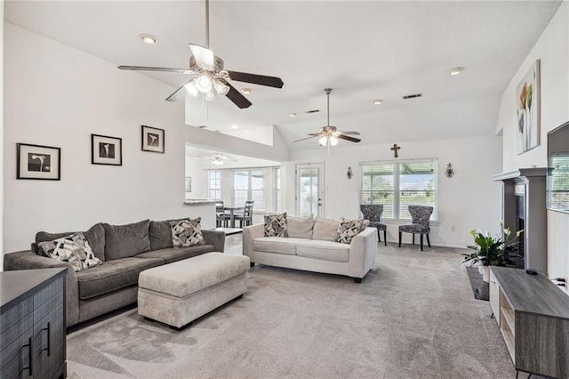 carpeted living room featuring ceiling fan and high vaulted ceiling