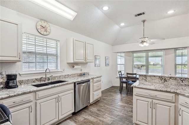 kitchen featuring white cabinetry, ceiling fan, stainless steel dishwasher, vaulted ceiling, and sink