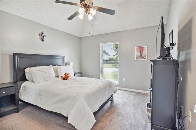 bedroom featuring carpet, ceiling fan, vaulted ceiling, and a textured ceiling