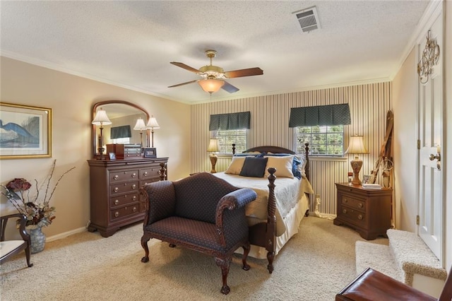 carpeted bedroom with ceiling fan, a textured ceiling, and ornamental molding