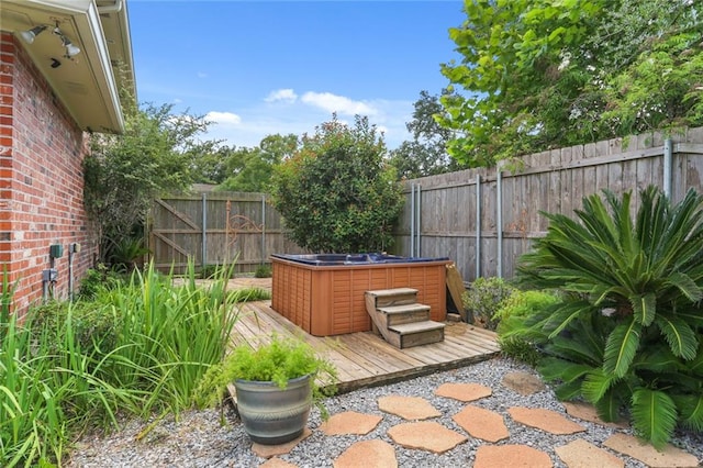 view of patio / terrace featuring a hot tub and a wooden deck