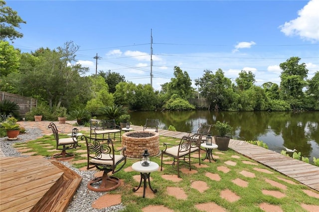 dock area with a patio, a water view, and a fire pit