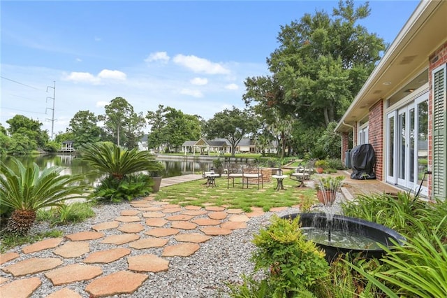 view of patio / terrace featuring area for grilling and a water view