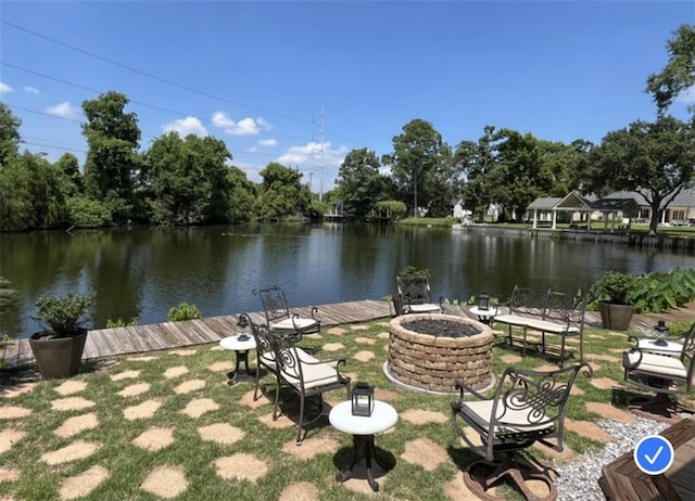 exterior space with a water view and a fire pit