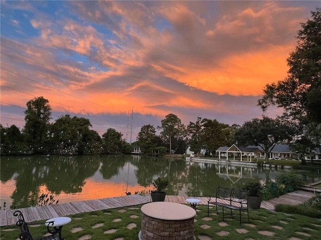 view of dock featuring a water view and an outdoor fire pit