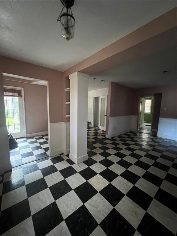 misc room with ceiling fan and decorative columns