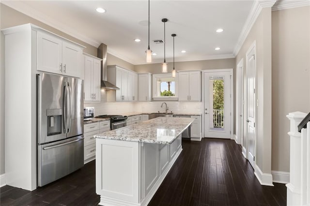 kitchen featuring white cabinetry, wall chimney exhaust hood, dark hardwood / wood-style flooring, stainless steel appliances, and a center island