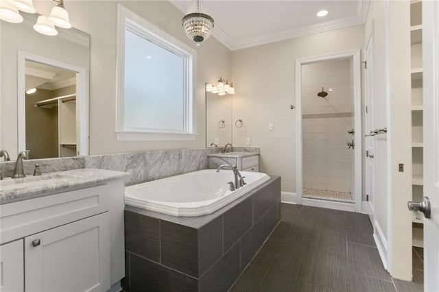 full bathroom with crown molding, a sink, a spacious closet, tiled shower, and a garden tub