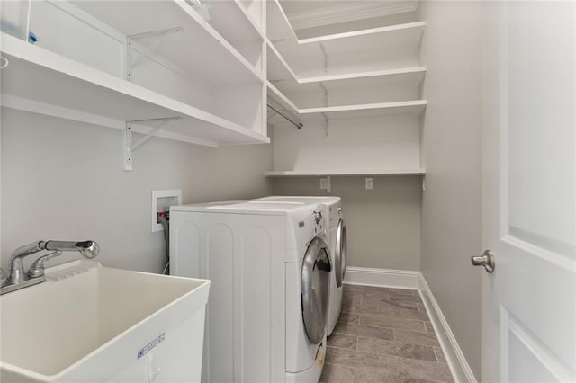 laundry room with washer and clothes dryer and sink