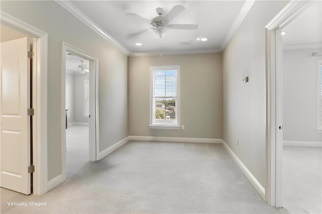 carpeted empty room featuring ornamental molding and ceiling fan