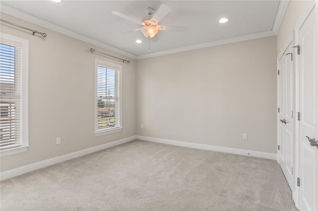 unfurnished bedroom with ceiling fan, light carpet, and crown molding