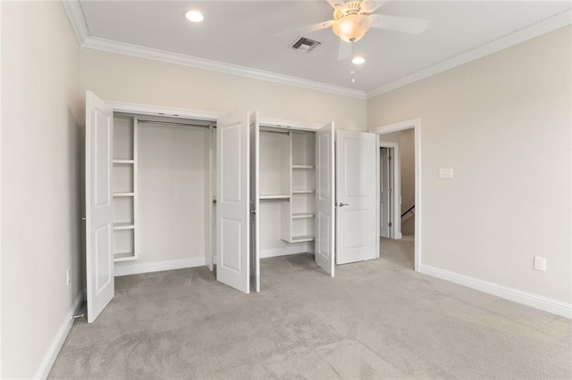 unfurnished bedroom with crown molding, baseboards, visible vents, and light carpet
