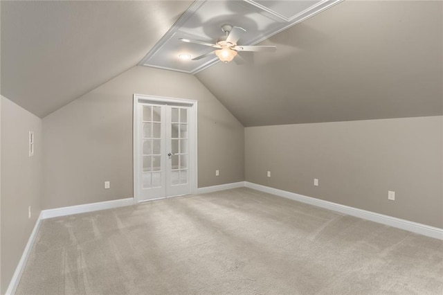 additional living space with ceiling fan, light carpet, baseboards, and lofted ceiling