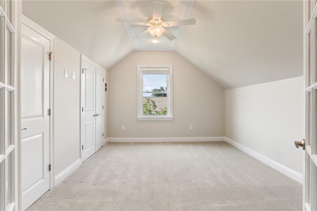 bonus room with light carpet, lofted ceiling, and ceiling fan