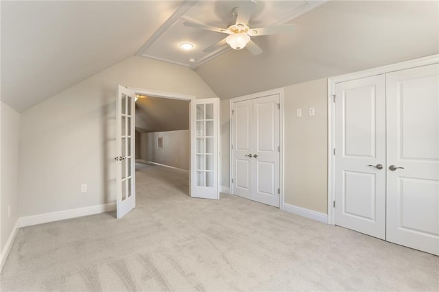 additional living space featuring light colored carpet, lofted ceiling, ceiling fan, and french doors