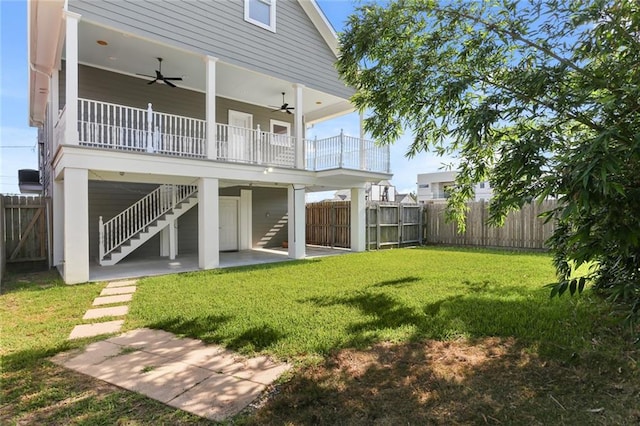 rear view of property with a lawn, a patio, and ceiling fan