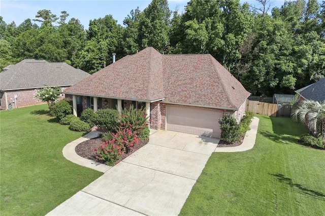 ranch-style house featuring a garage and a front lawn