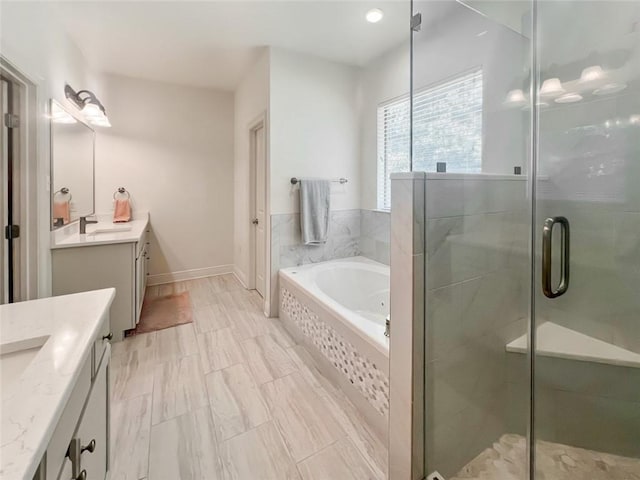 bathroom with vanity and independent shower and bath