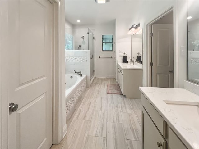 bathroom with vanity and separate shower and tub