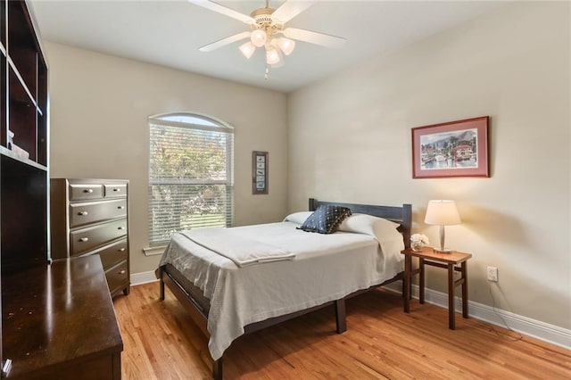 bedroom with light hardwood / wood-style floors and ceiling fan