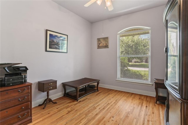 sitting room featuring ceiling fan, light hardwood / wood-style flooring, and a healthy amount of sunlight