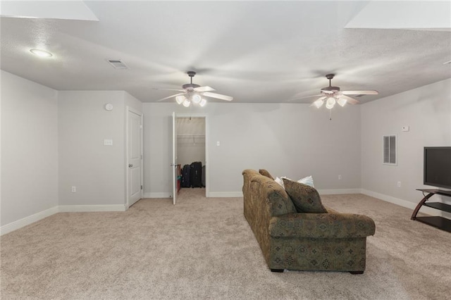 carpeted living room featuring ceiling fan