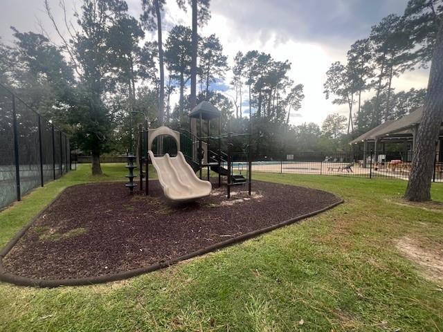 view of playground with a lawn