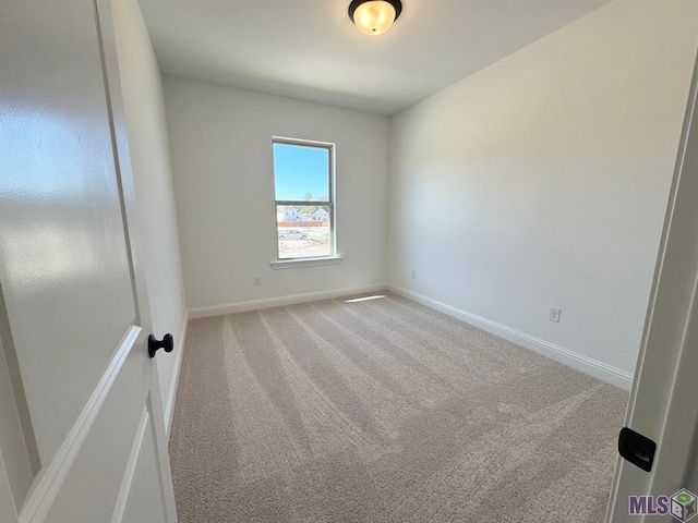 spare room with light carpet