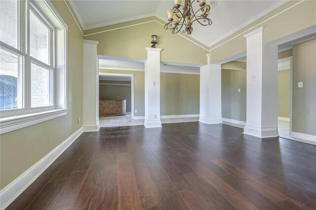 empty room with lofted ceiling, decorative columns, and dark wood-type flooring