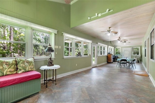 sunroom featuring ceiling fan and a wealth of natural light