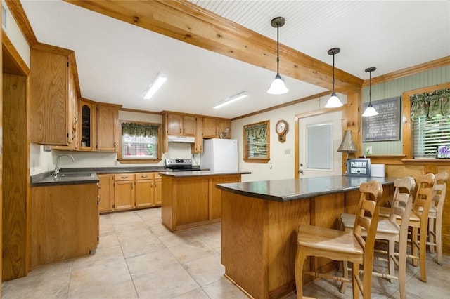 kitchen with electric stove, hanging light fixtures, a center island, white refrigerator, and ornamental molding