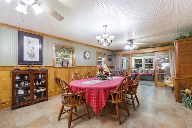 tiled dining area featuring ceiling fan with notable chandelier, crown molding, and plenty of natural light