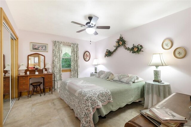 tiled bedroom featuring a closet and ceiling fan