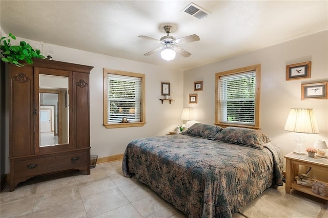 tiled bedroom featuring ceiling fan