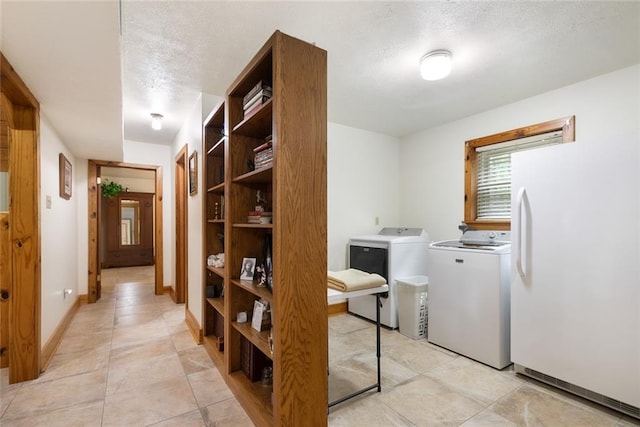 clothes washing area featuring separate washer and dryer and a textured ceiling