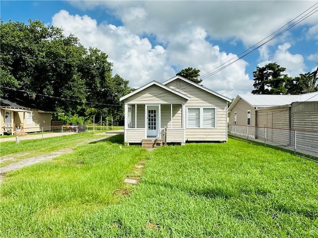 rear view of property with a lawn