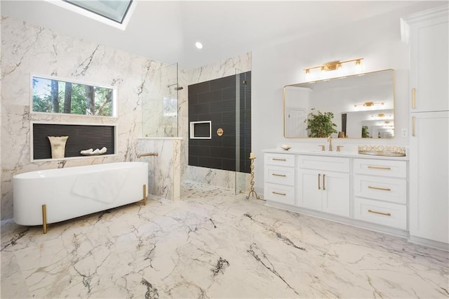 full bath featuring marble finish floor, a marble finish shower, a skylight, a freestanding bath, and vanity