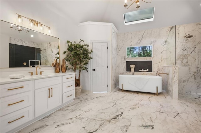 full bath with vanity, marble finish floor, a marble finish shower, and a freestanding bath