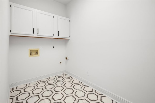 clothes washing area featuring hookup for a washing machine, baseboards, cabinet space, electric dryer hookup, and hookup for a gas dryer