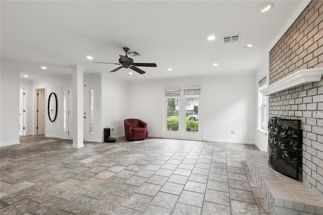 unfurnished living room with ceiling fan, ornamental molding, and a brick fireplace