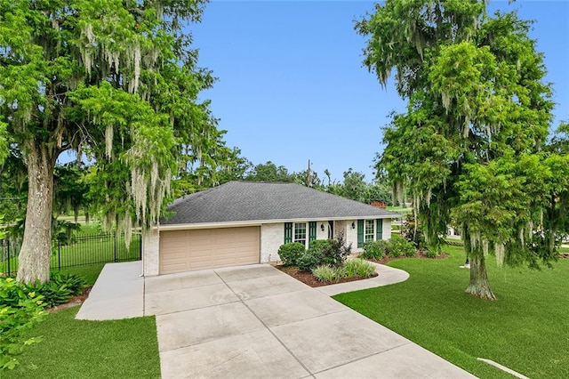 ranch-style home featuring a front lawn and a garage