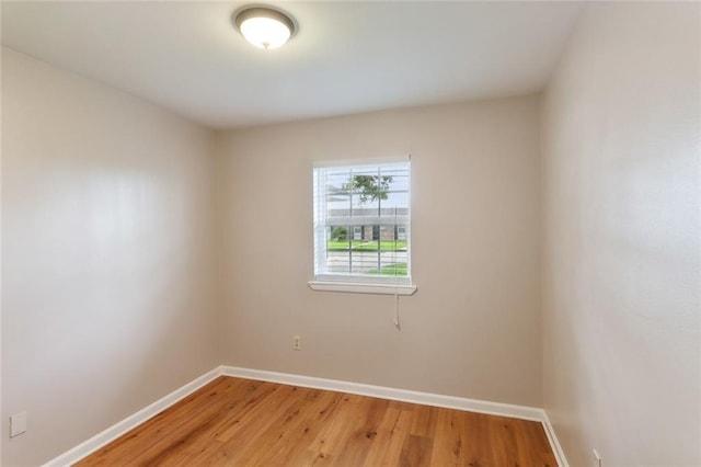 unfurnished room with hardwood / wood-style floors