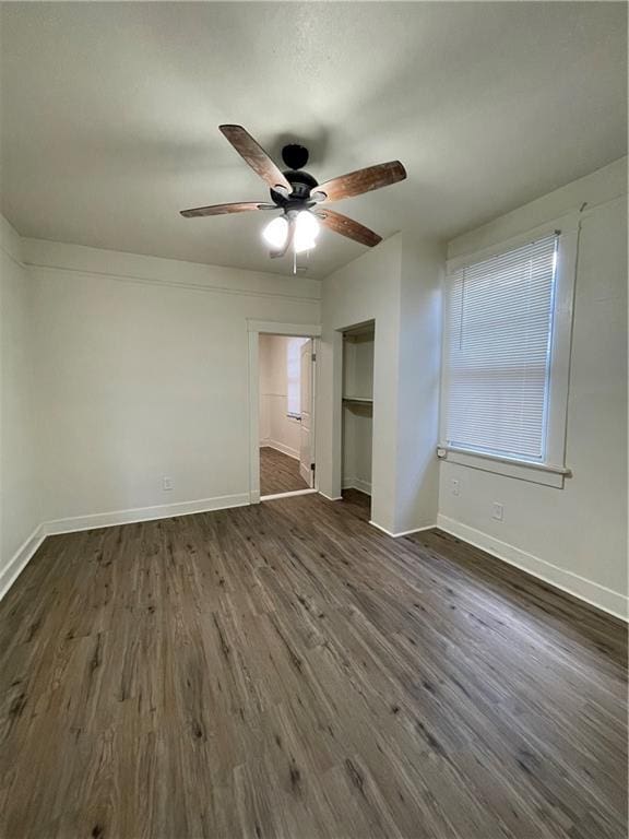 unfurnished bedroom with dark hardwood / wood-style flooring and ceiling fan