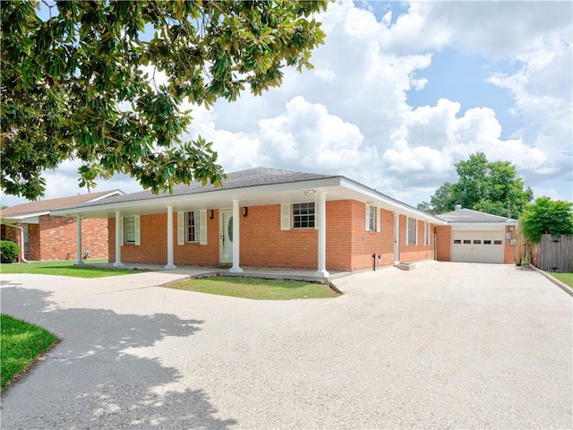 ranch-style house featuring a garage and covered porch