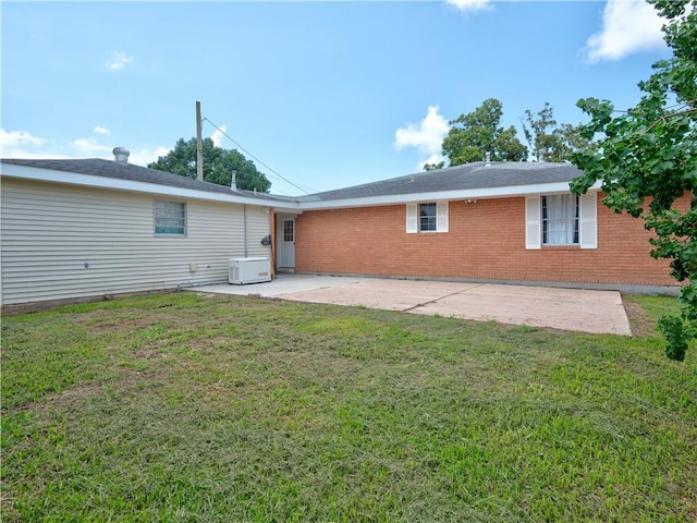 rear view of house with a patio area and a yard