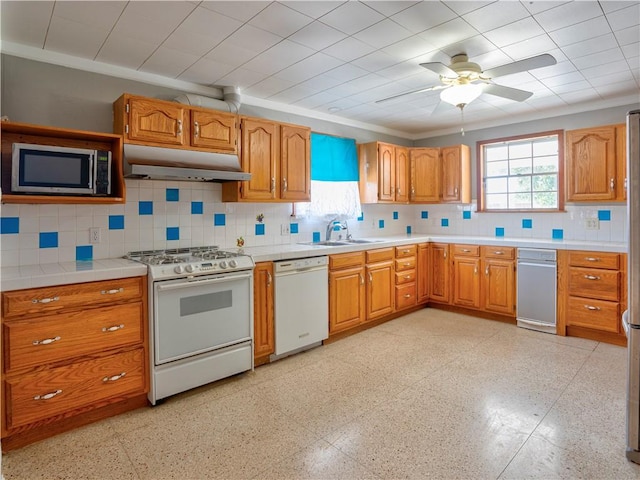 kitchen featuring sink, ceiling fan, white appliances, and tasteful backsplash