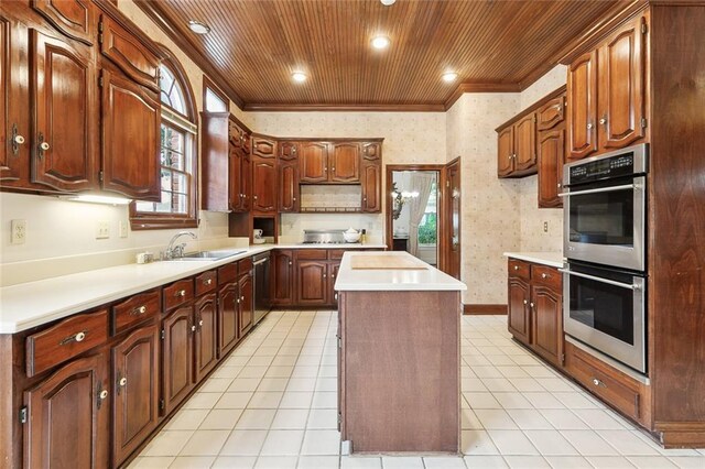 kitchen with light tile patterned floors, a center island, stainless steel appliances, wooden ceiling, and sink