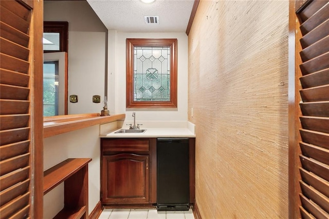 bathroom featuring vanity, a textured ceiling, and tile patterned flooring